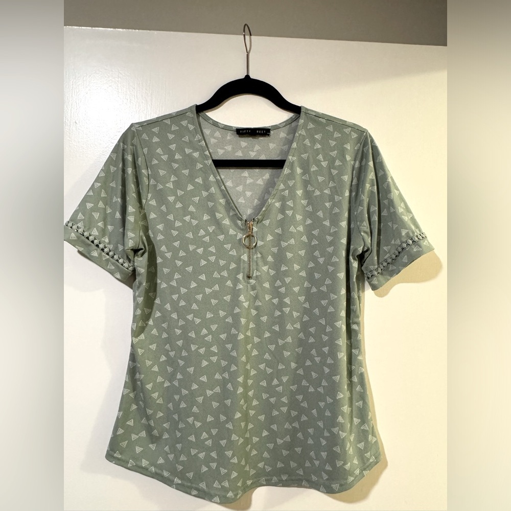 Short sleeve Sage green blouse size small with geometric detail and gold zipper